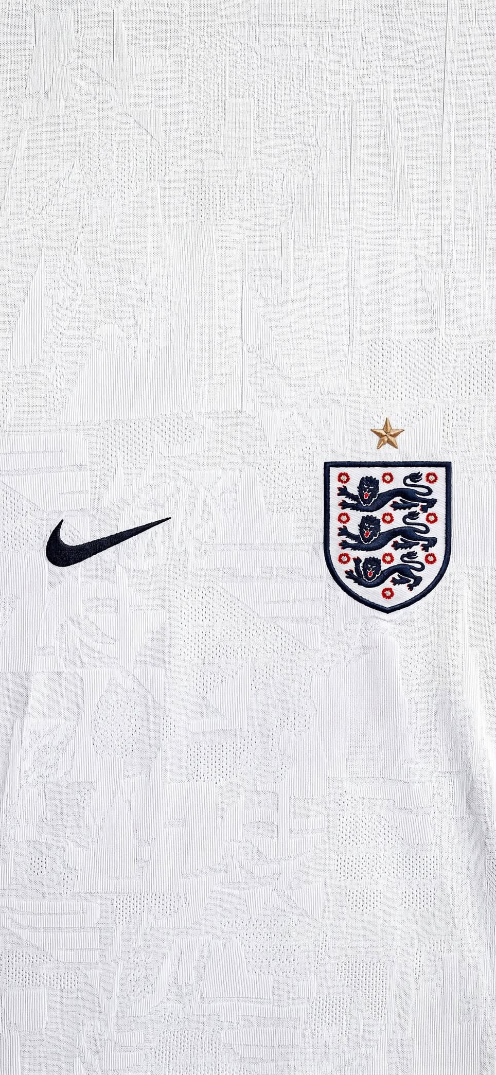 The England national team white soccer jersey showcases intricate fabric textures against a minimalist background