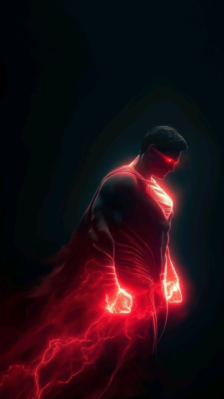 Superman stands against a black background, outlined by red light that emphasizes strength
