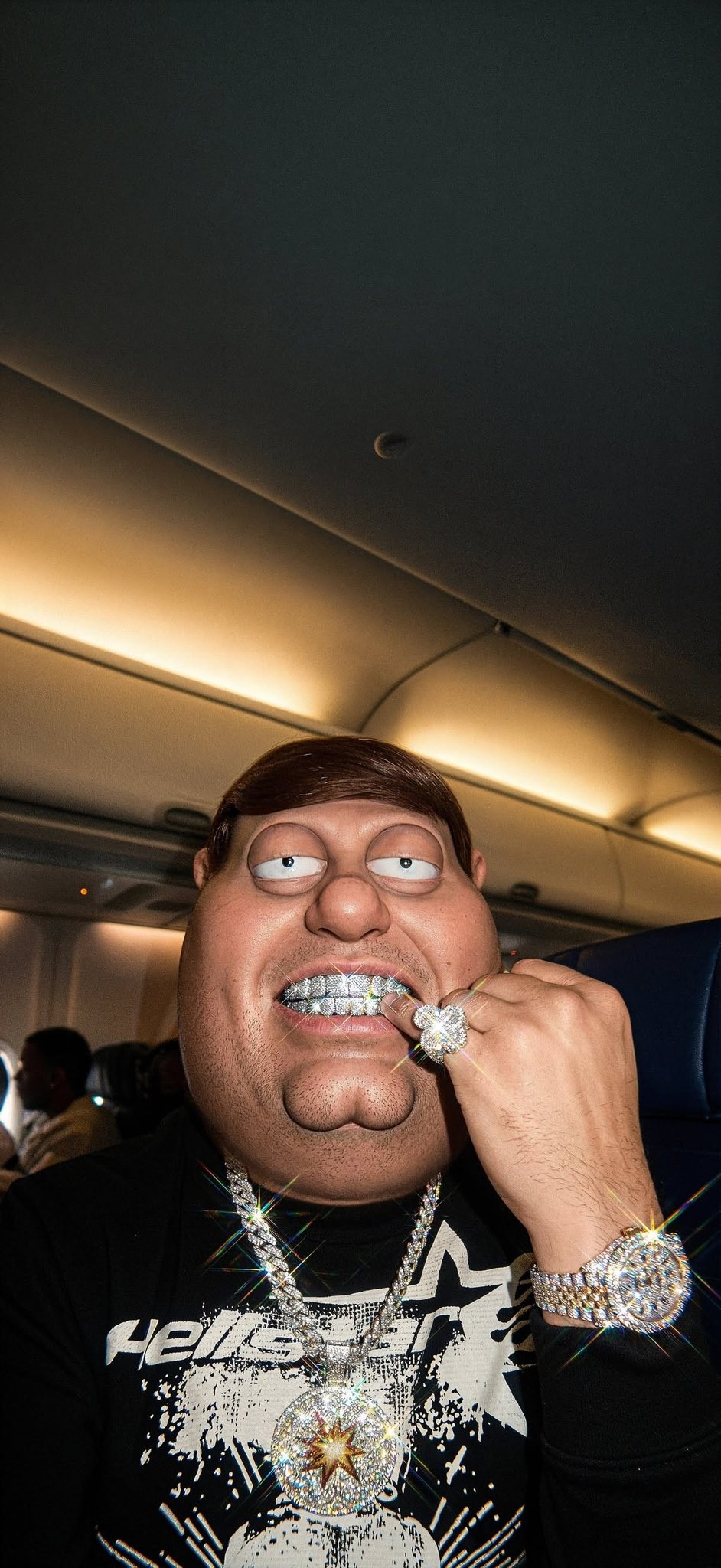 In the cabin, a person wears luxurious diamond jewelry contrasted against a black top