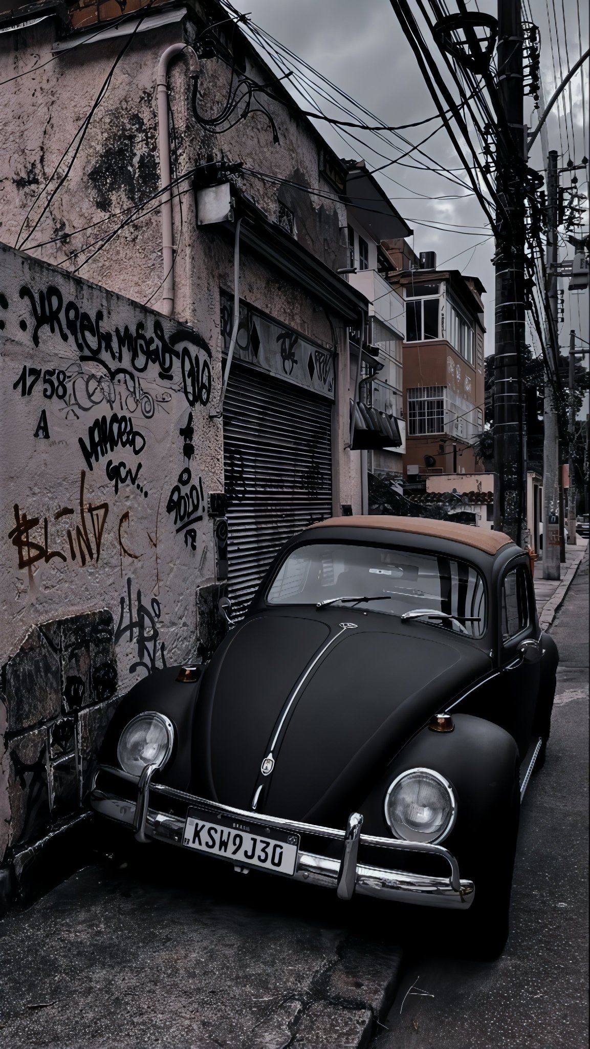 Der matte schwarze Vintagekäfer neben der Graffiti-Wand zeigt eine rebellische Straßenatmosphäre