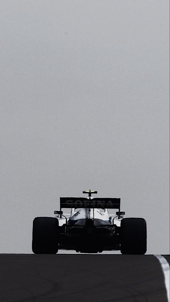F1 car silhouette against a minimal gray-white background
