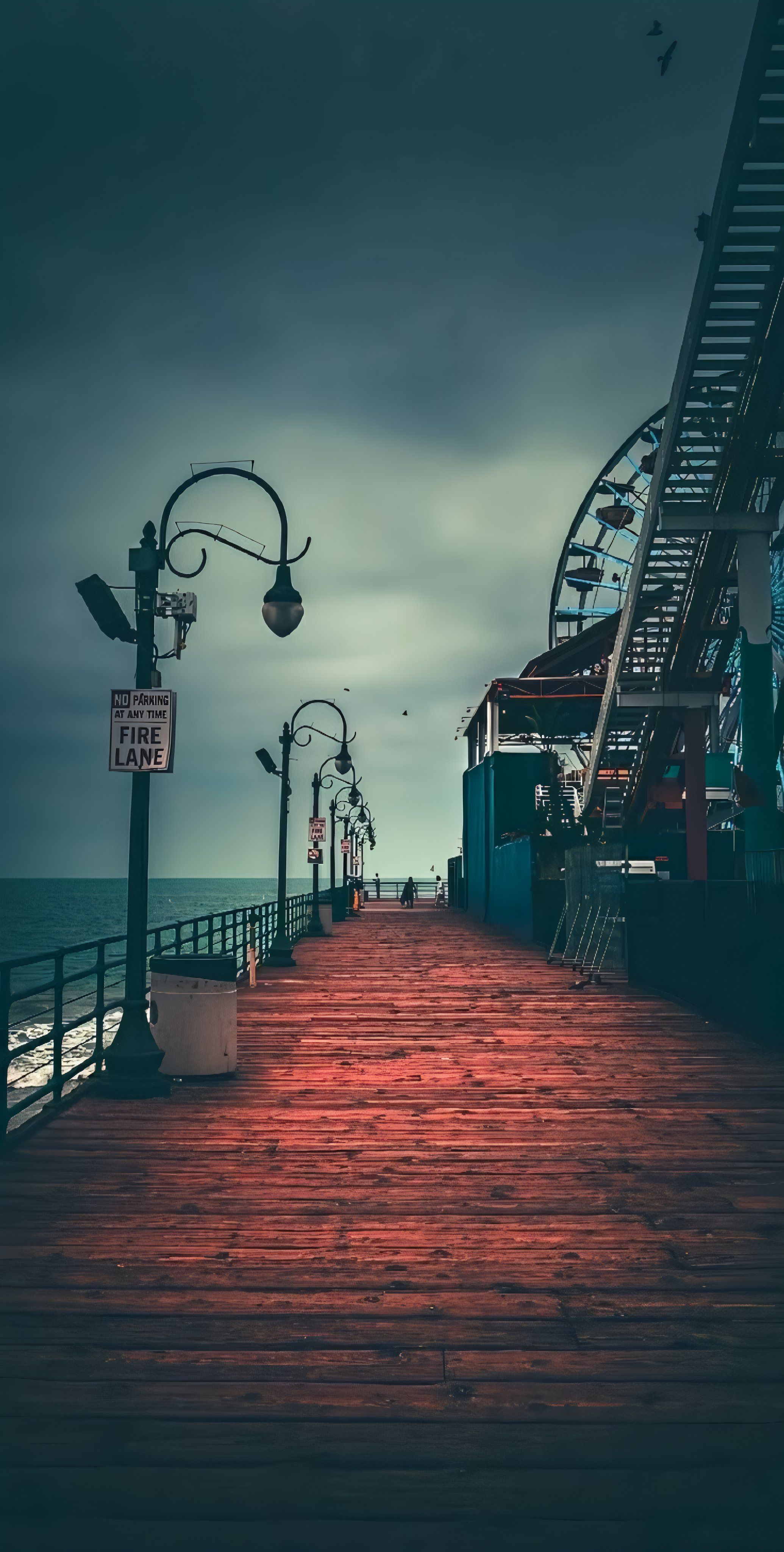 This photograph depicts a pier scene with a cinematic and moody aesthetic