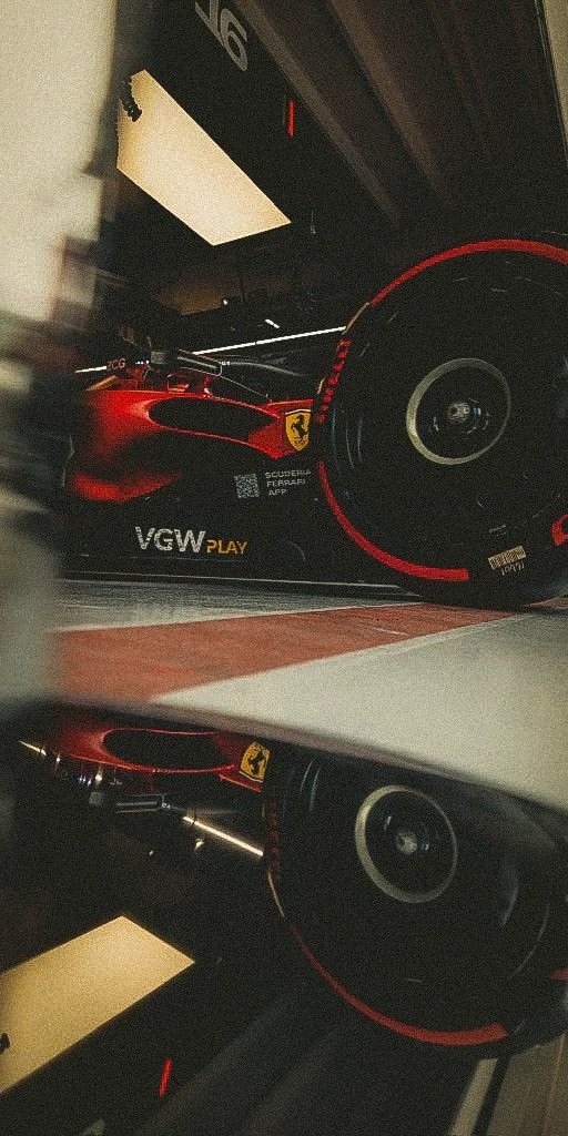 A dark cinematic close-up photograph of a Ferrari F1 car