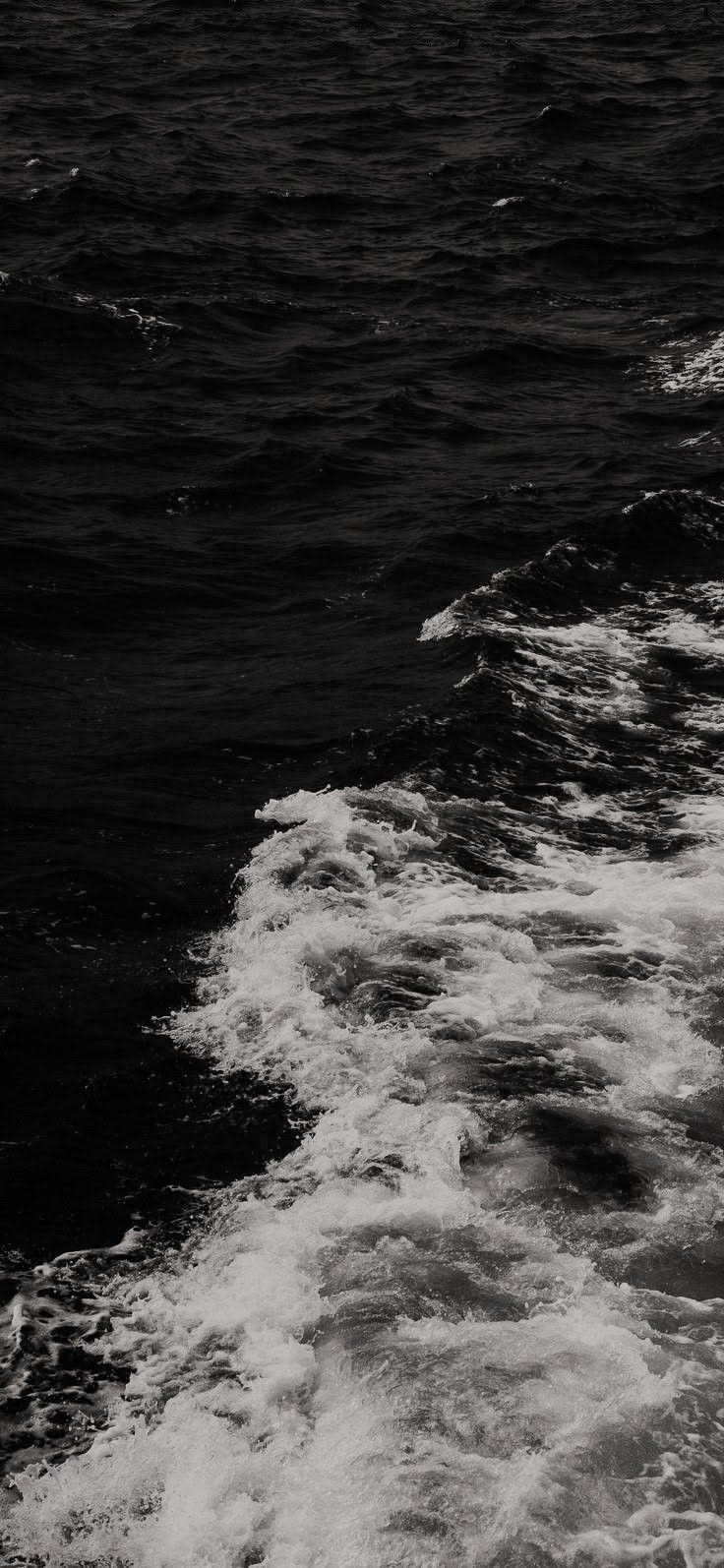 High contrast black and white close-up of the sea captures the dynamics of waves and water