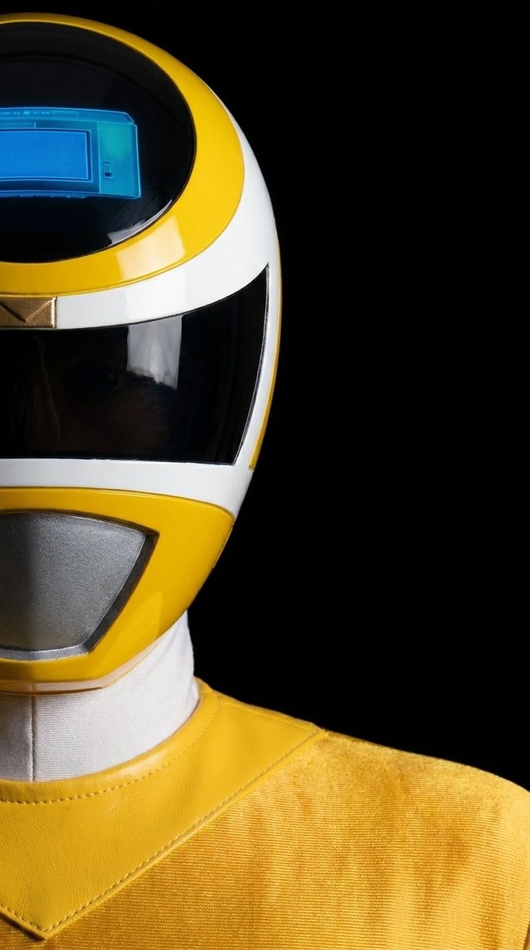 This is a portrait of a yellow Power Ranger featuring a glossy helmet and unique costume design