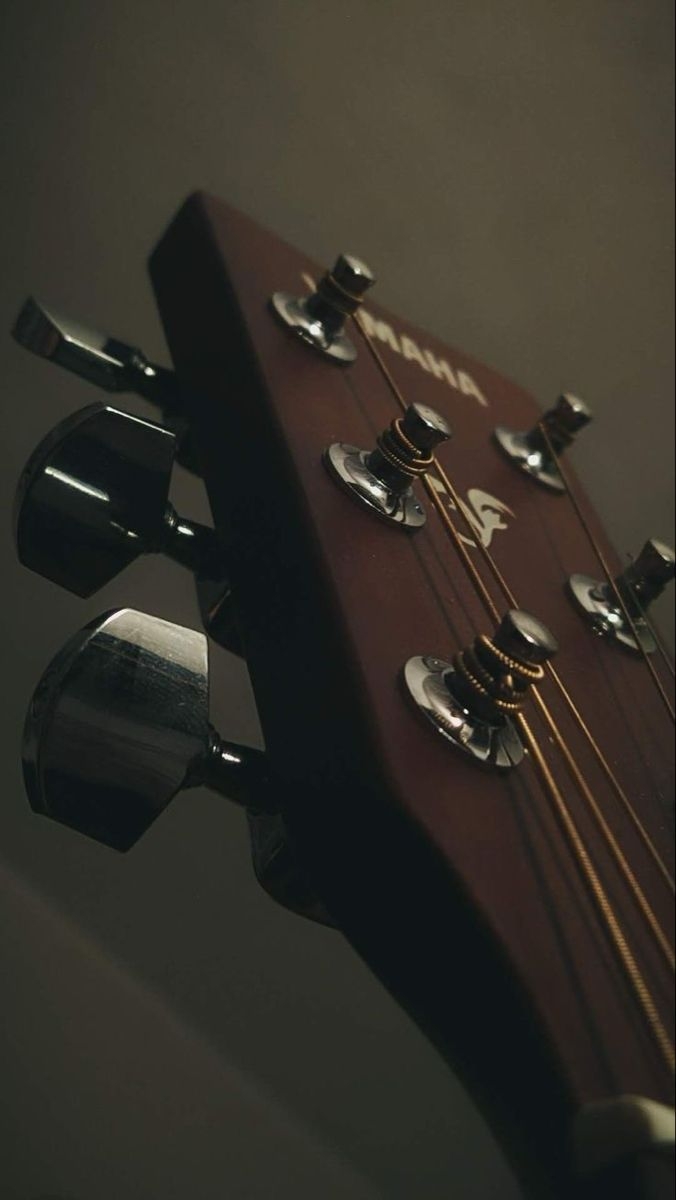 Close-up of a Yamaha acoustic guitar headstock from a low angle, creating a nostalgic atmosphere