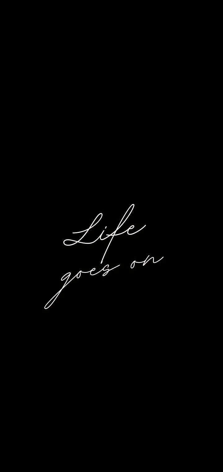 A minimalist black and white wallpaper features the phrase Life goes on, perfect for an inspirational phone background