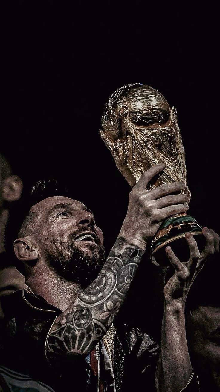 HD wallpaper of Messi holding the World Cup trophy