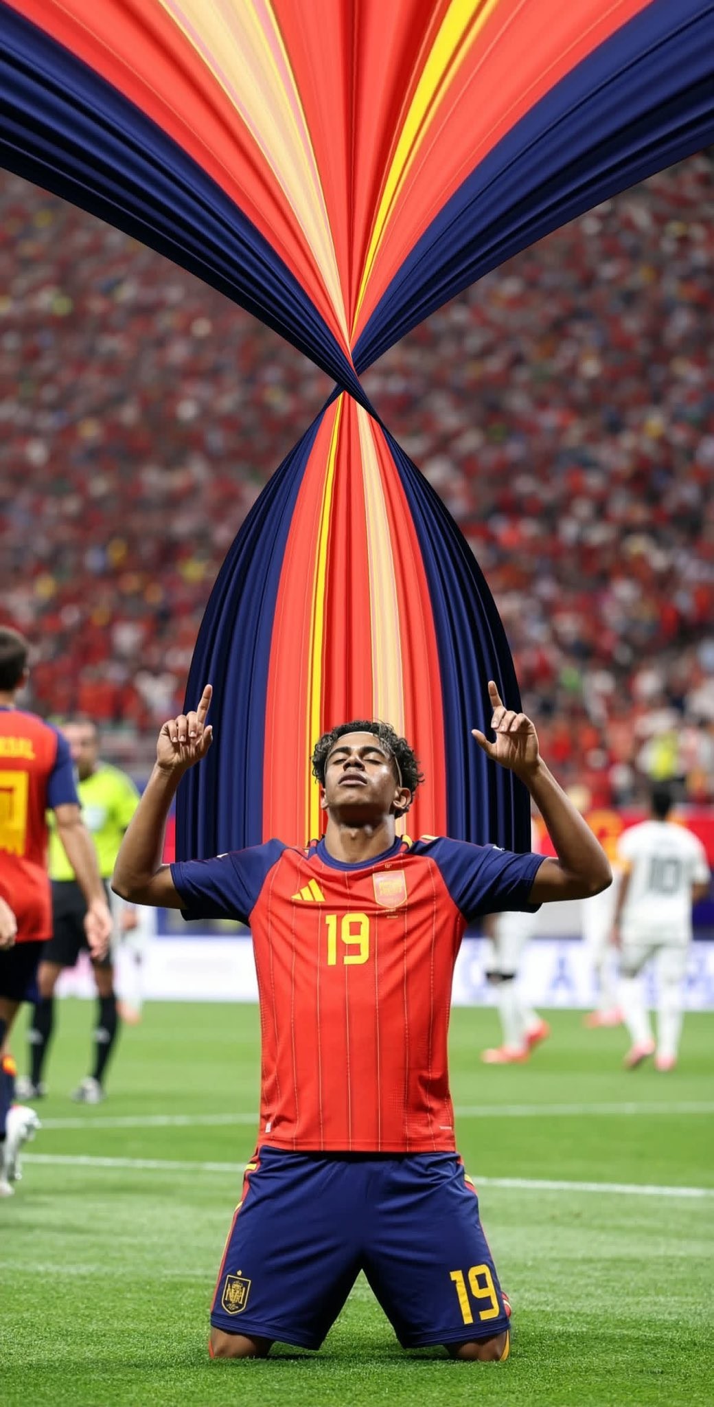 Spanish soccer player in number 19 jersey kneels in celebration, pointing hands to the sky.