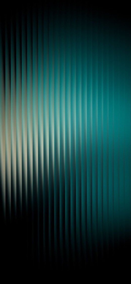 Multiple layers of rainbow-colored metal arcs overlap the Apple logo