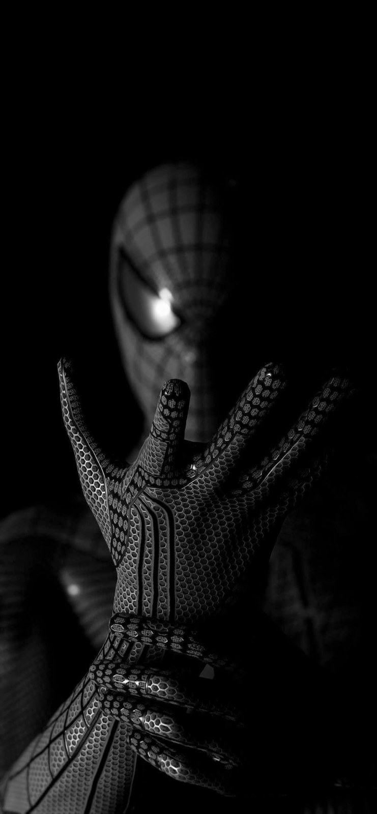 A black combat glove makes a double-finger shooting gesture, showcasing a cold metallic texture