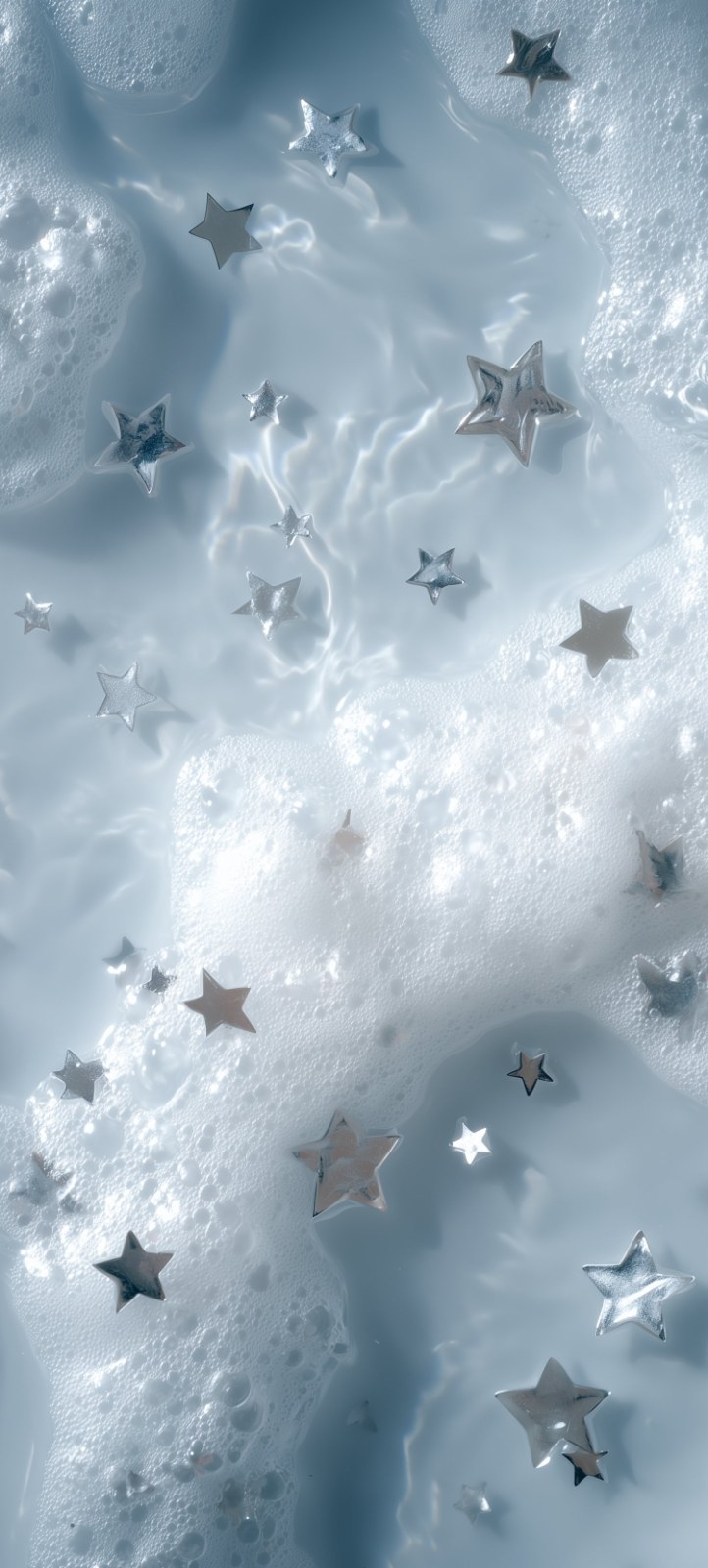 A superfície de um líquido azul claro flutua com espuma branca e estrelas prateadas em forma de pentágono