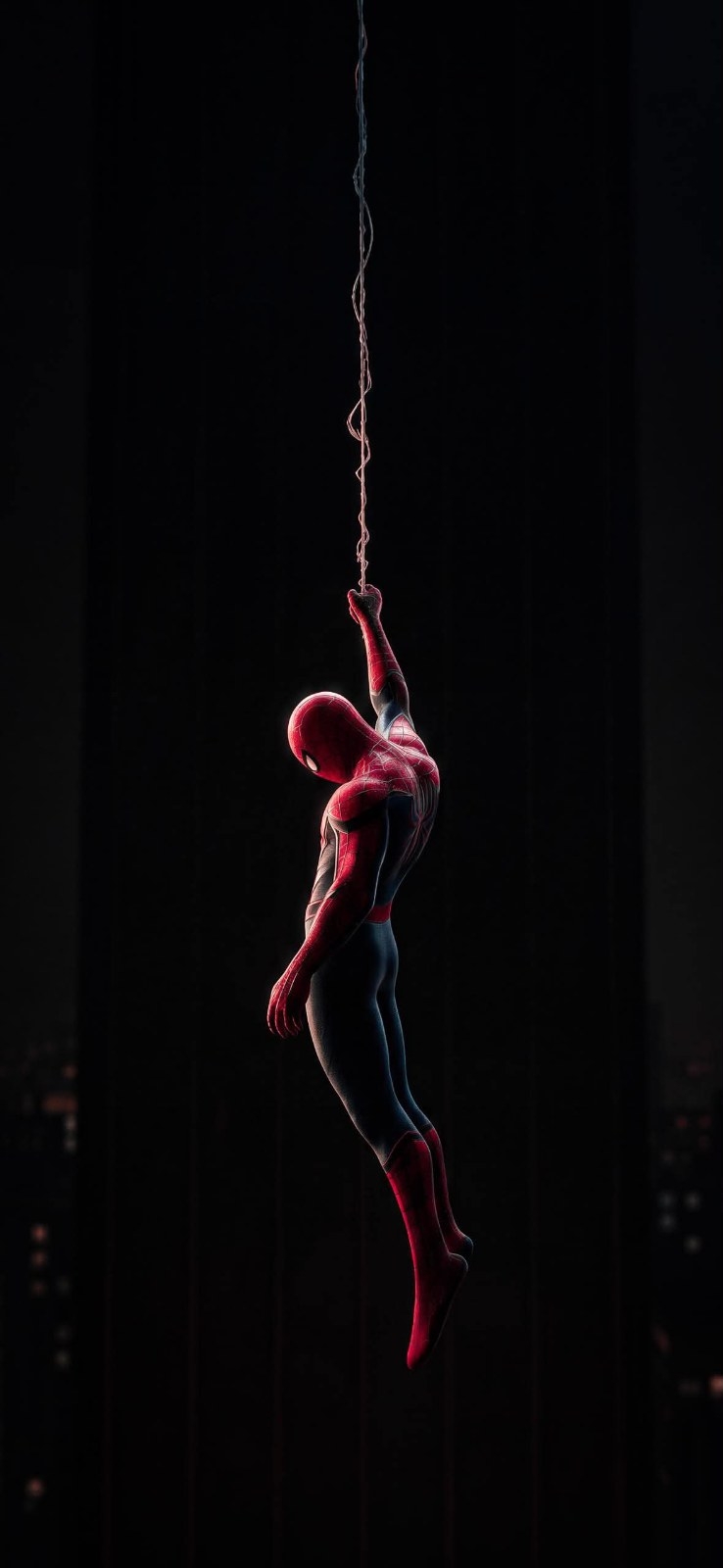 A character in a red and blue tight suit is hanging in a dark space