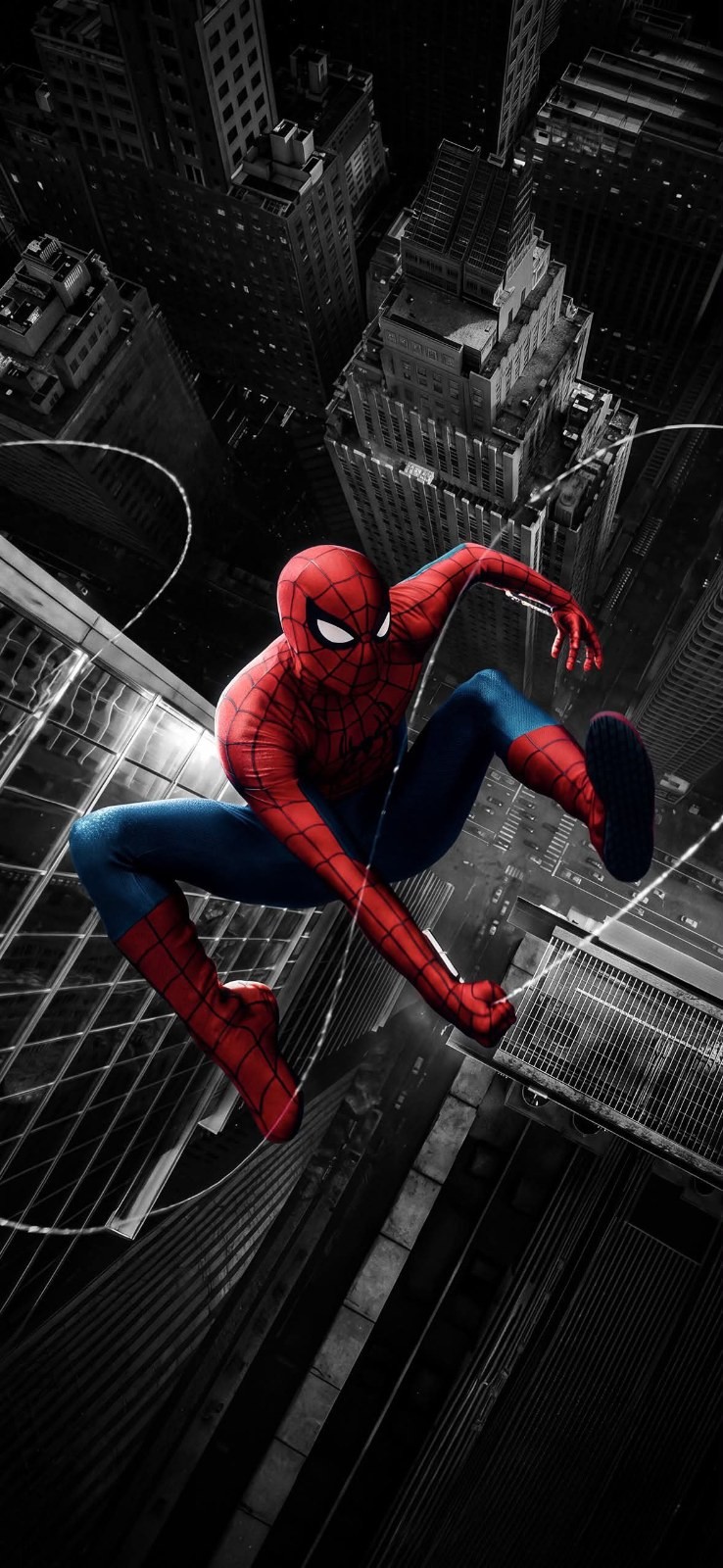 A character in a red and blue suit crouches between skyscrapers while shooting web