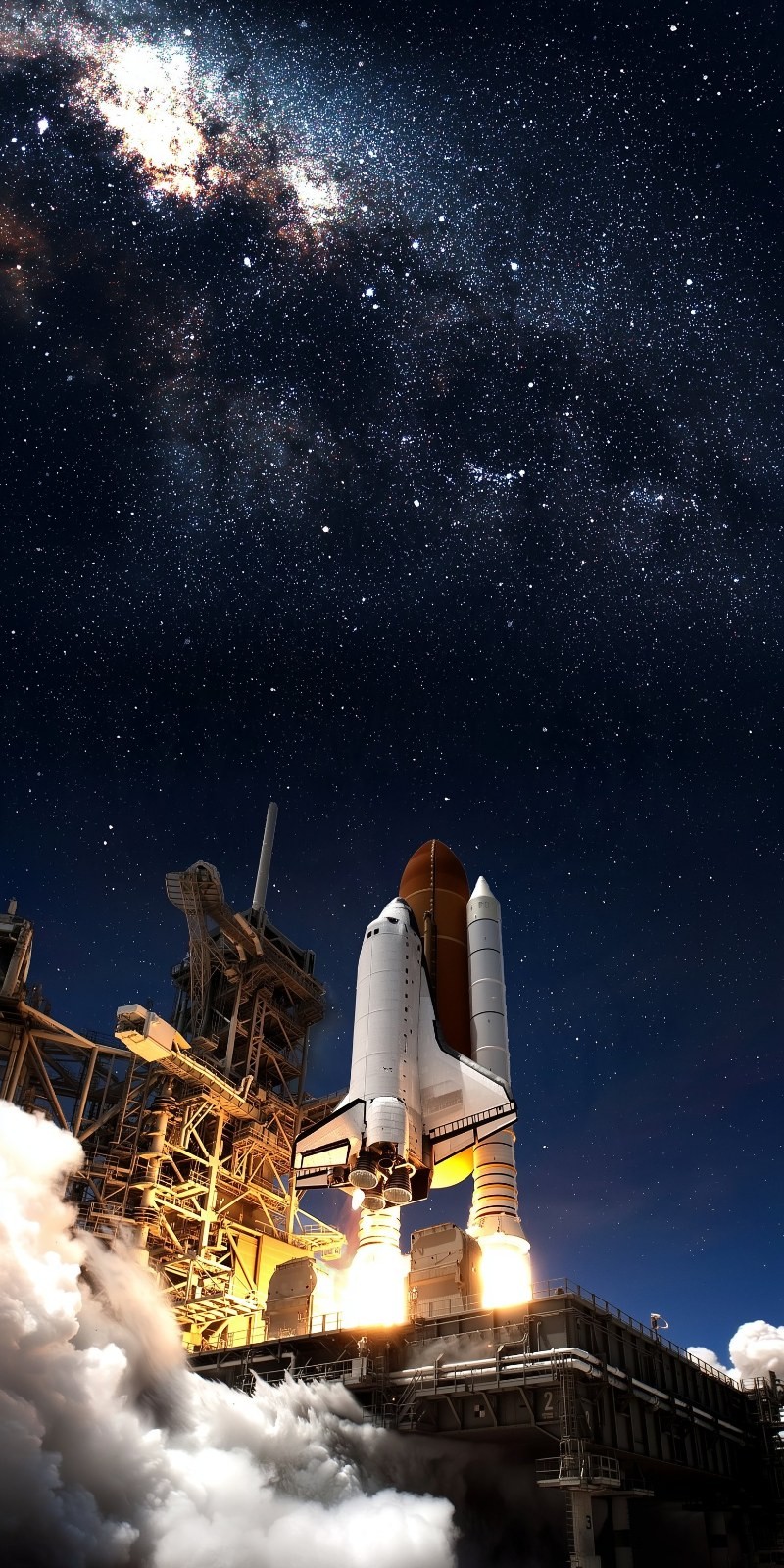 A white space shuttle launches into the night sky