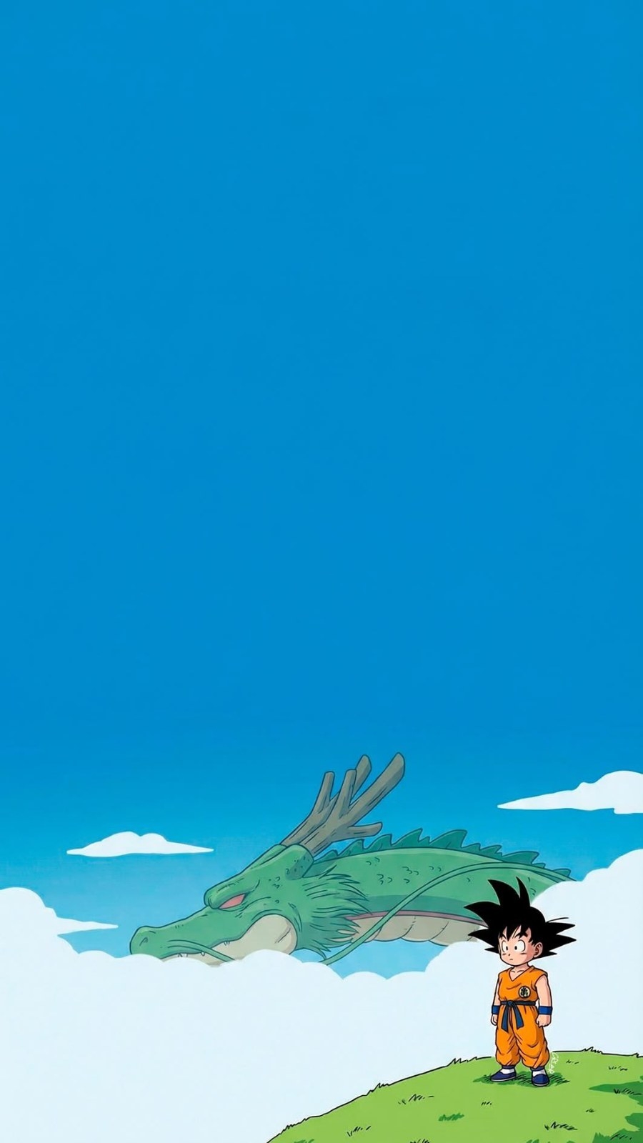 A boy in an orange martial arts outfit stands on a grassy slope facing a green dragon emerging from the clouds