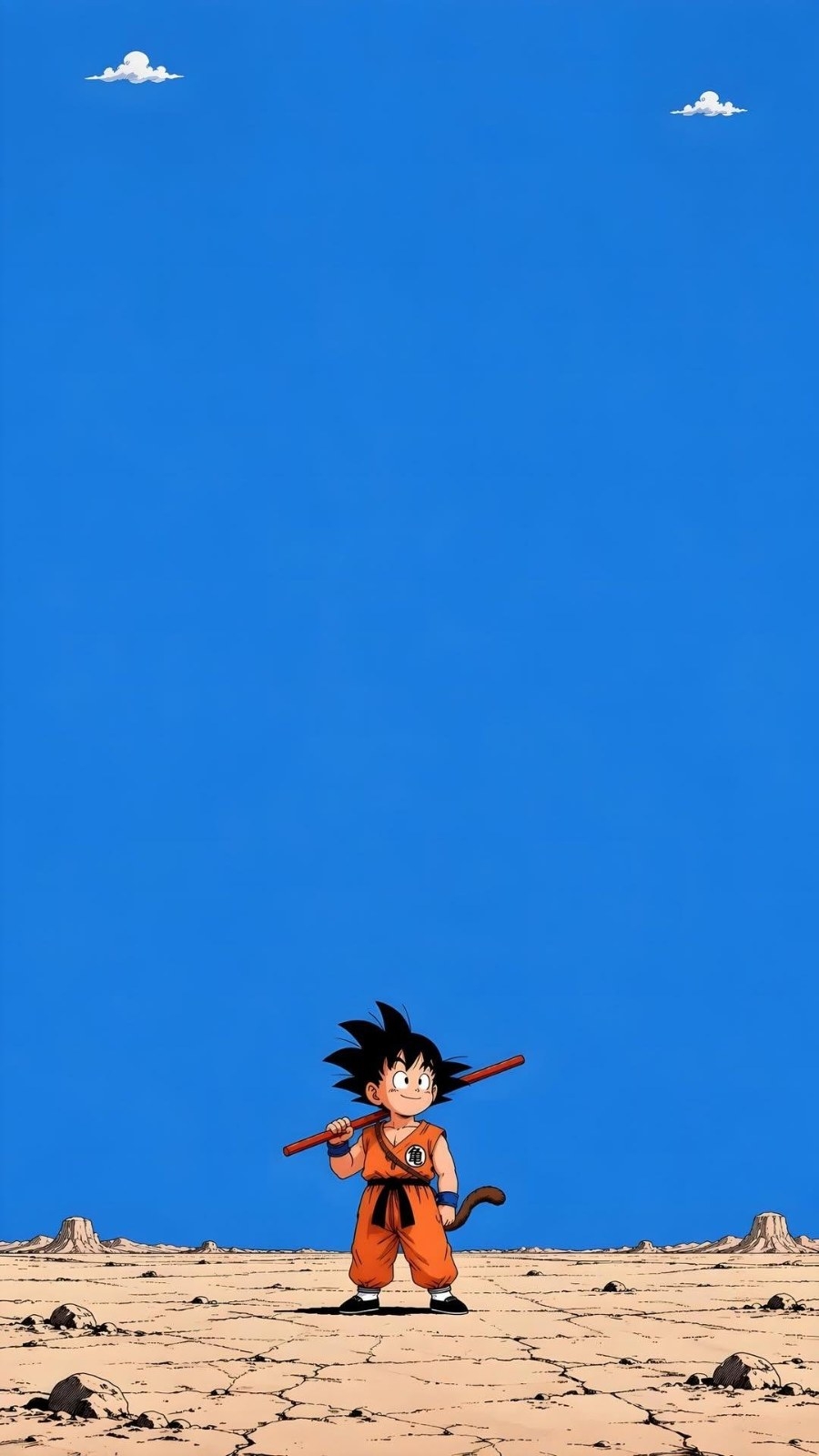 A boy in an orange martial arts uniform carries a red staff in a barren desert