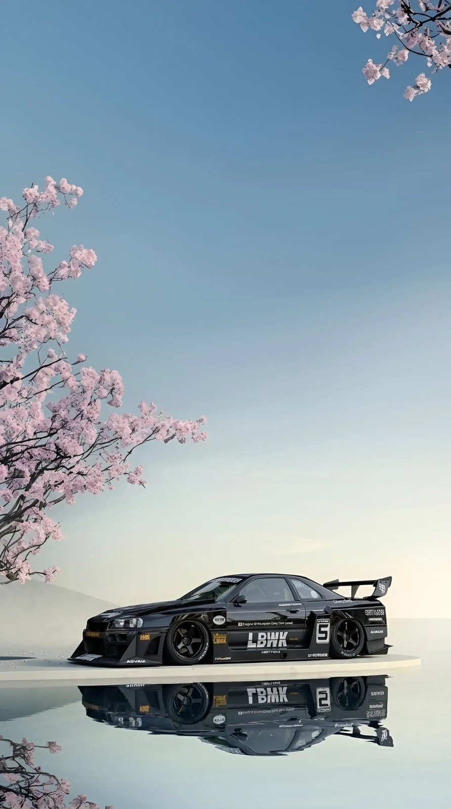 Black widebody sports car parked on white platform with cherry blossoms
